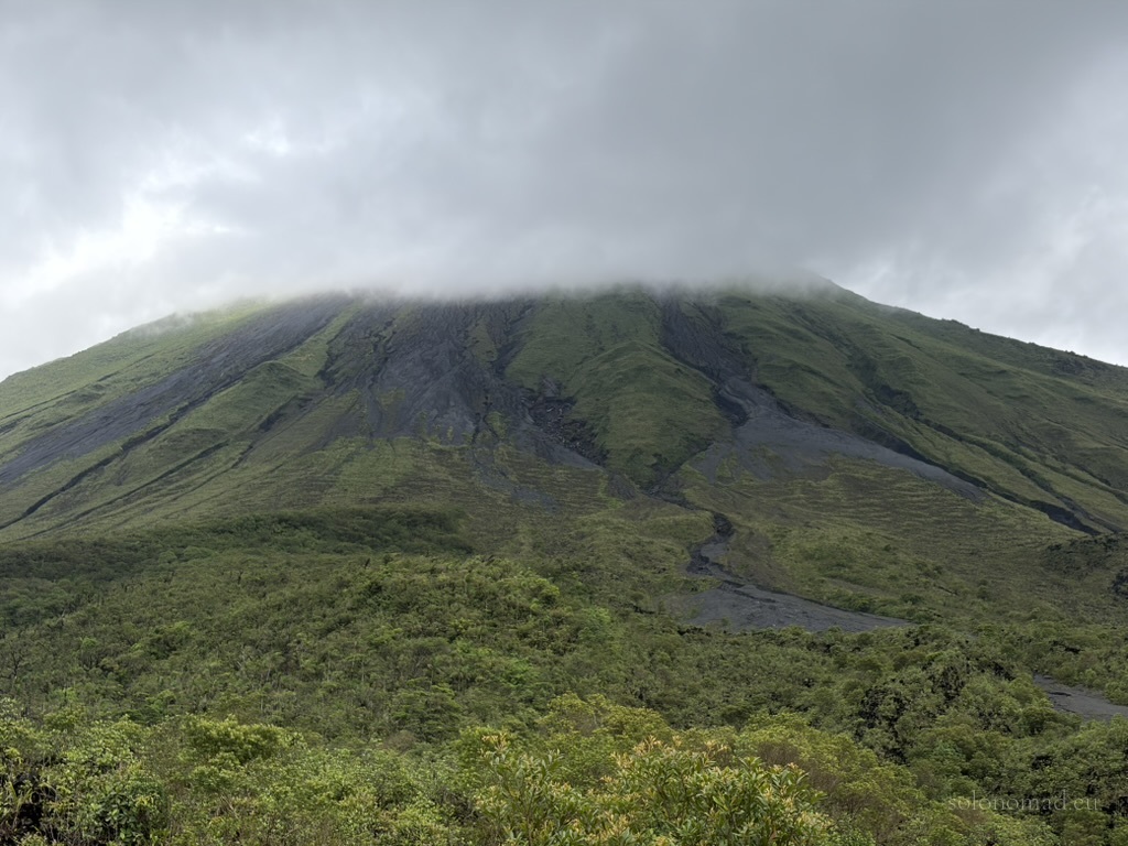 The mystical peak of Arenal Volcano in Costa Rica shrouded in dense rainforest clouds